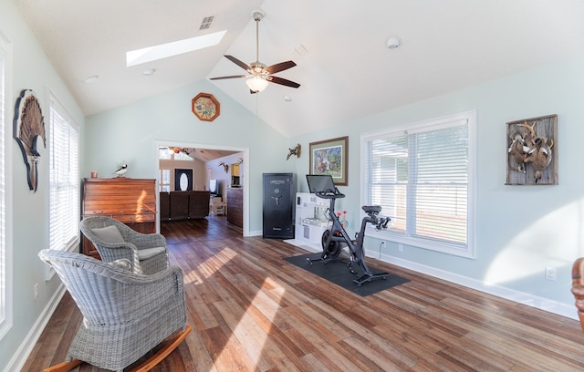 exercise room with ceiling fan, dark wood-type flooring, and a healthy amount of sunlight