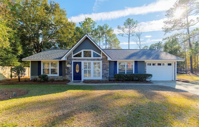 view of front of home with a garage and a front lawn