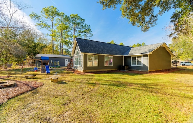 exterior space featuring a front yard, central air condition unit, and a playground