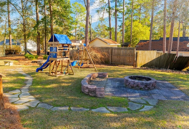 view of yard with a playground and a fire pit