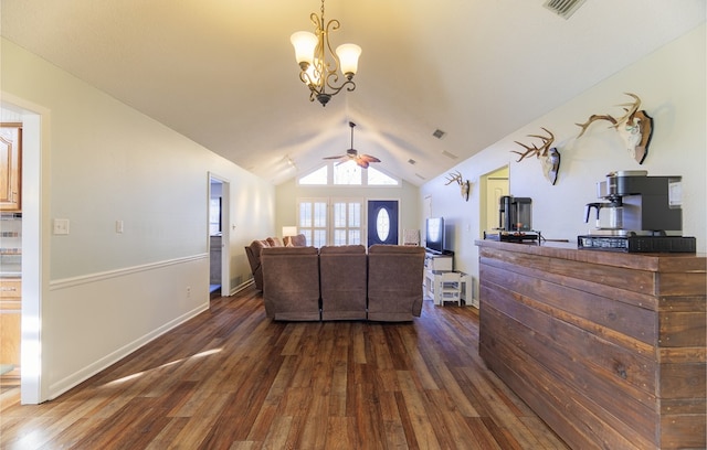 living room with vaulted ceiling, dark hardwood / wood-style flooring, and ceiling fan with notable chandelier