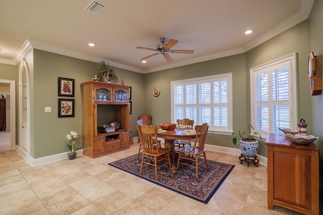 dining space featuring ceiling fan, crown molding, and light tile patterned floors