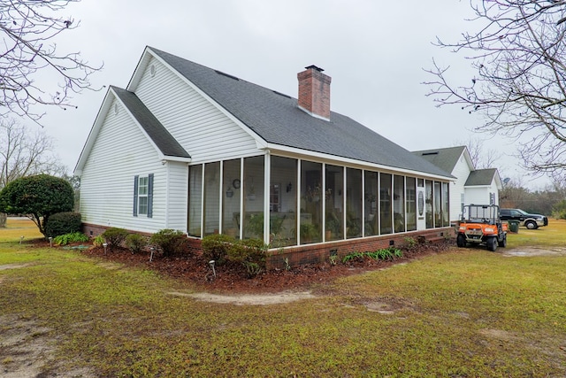 view of side of property with a yard and a sunroom