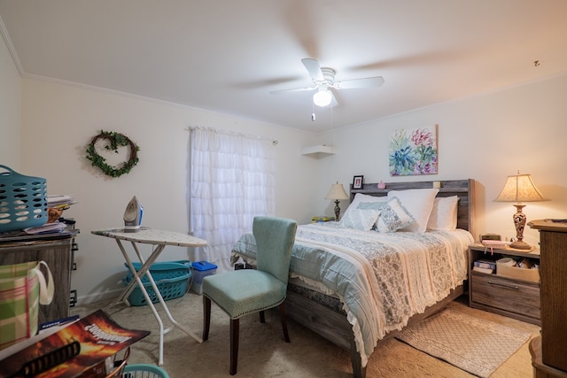 carpeted bedroom featuring ornamental molding and ceiling fan