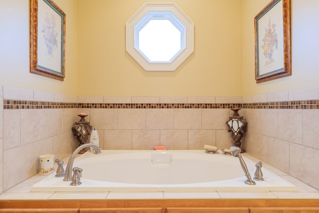 bathroom with a relaxing tiled tub