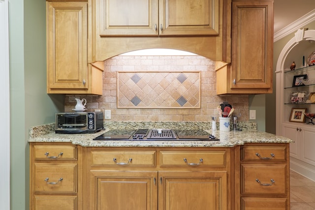 kitchen with backsplash, crown molding, light stone countertops, black electric cooktop, and light tile patterned flooring