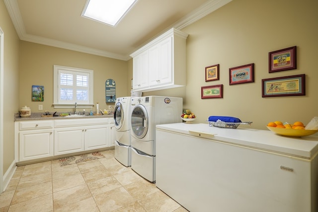 washroom with cabinets, separate washer and dryer, crown molding, and sink