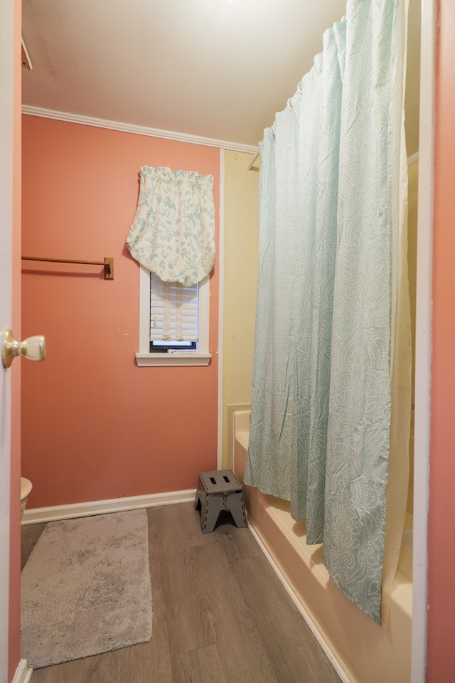 bathroom featuring shower / bath combination with curtain, crown molding, and wood-type flooring