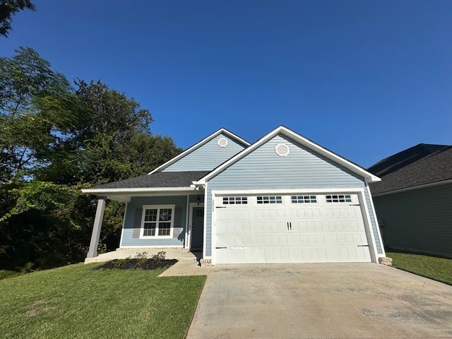 view of front of property with a front yard and a garage