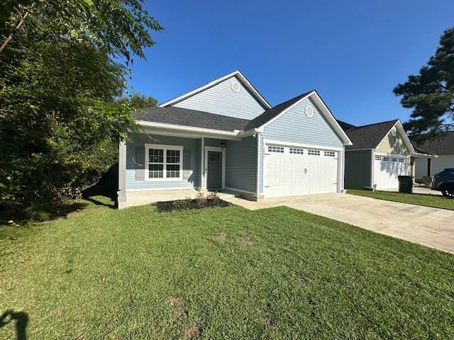 view of front of property with a garage and a front lawn