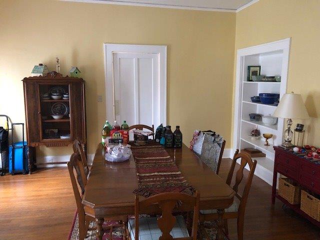 dining room with hardwood / wood-style flooring and ornamental molding