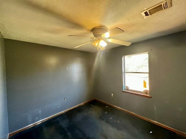 empty room with ceiling fan, a textured ceiling, and carpet flooring