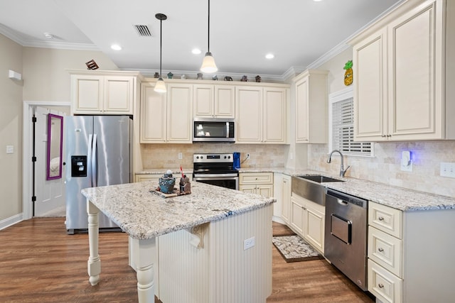 kitchen with pendant lighting, dark hardwood / wood-style floors, a kitchen island, and stainless steel appliances