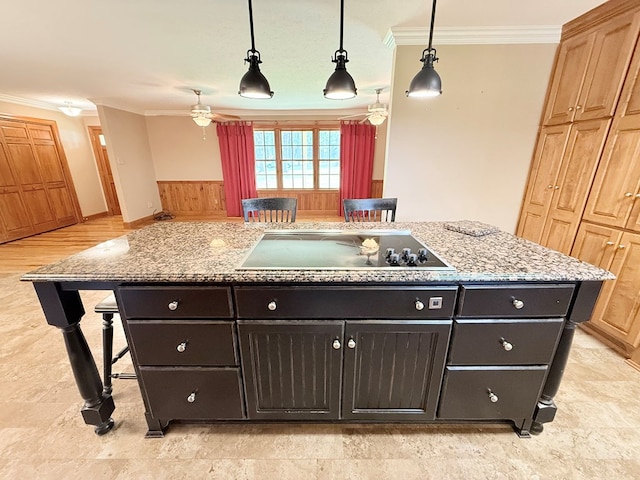 5951 Tallokas Rd, Pavo, GA 31778 - kitchen featuring black electric cooktop, ornamental molding, a ceiling fan, a kitchen bar, and a kitchen island