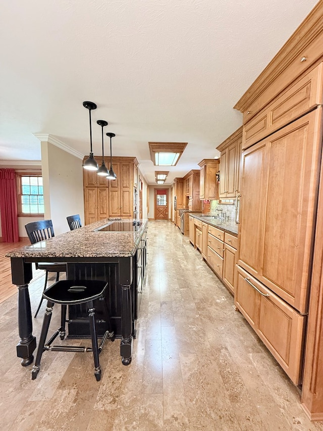 5951 Tallokas Rd, Pavo, GA 31778 - kitchen featuring a breakfast bar, black electric stovetop, stone counters, ornamental molding, and an island with sink