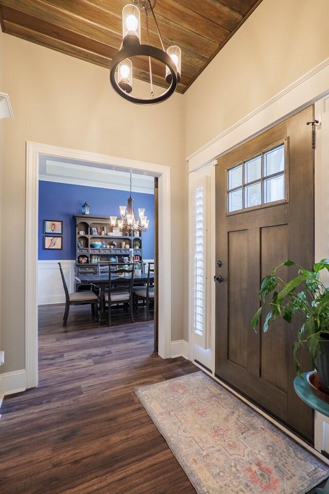 foyer with wooden ceiling, dark wood-type flooring, and a chandelier