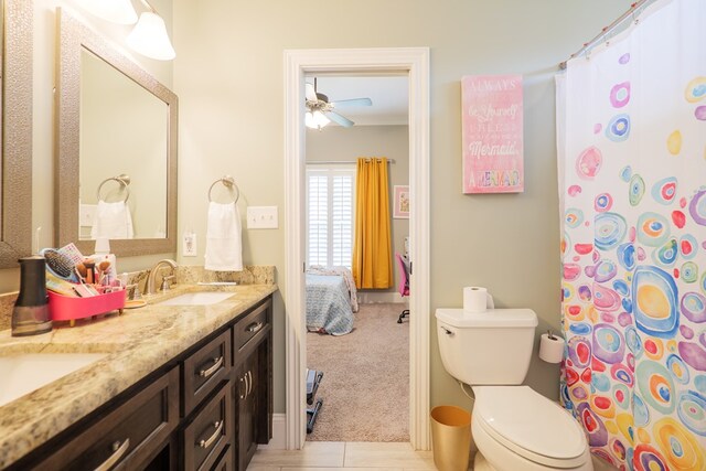 bathroom featuring tile patterned flooring, ceiling fan, toilet, and vanity