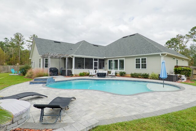 view of pool featuring an in ground hot tub, a pergola, cooling unit, a sunroom, and a patio