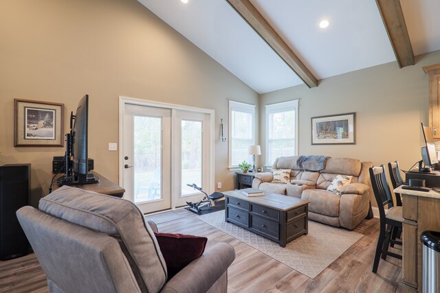 living room with beamed ceiling, light wood-type flooring, and high vaulted ceiling