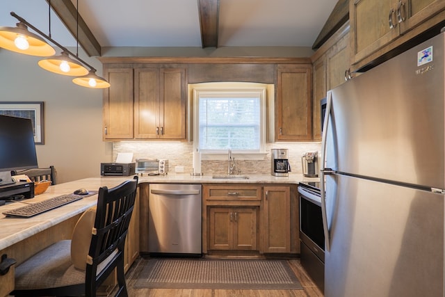 kitchen with dark hardwood / wood-style flooring, tasteful backsplash, stainless steel appliances, sink, and decorative light fixtures