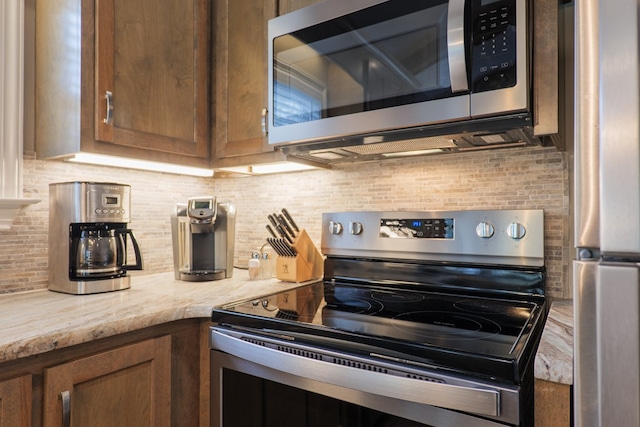 kitchen with backsplash and stainless steel appliances