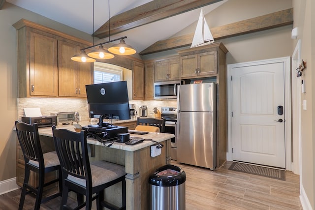 kitchen featuring vaulted ceiling with beams, decorative backsplash, hanging light fixtures, and appliances with stainless steel finishes