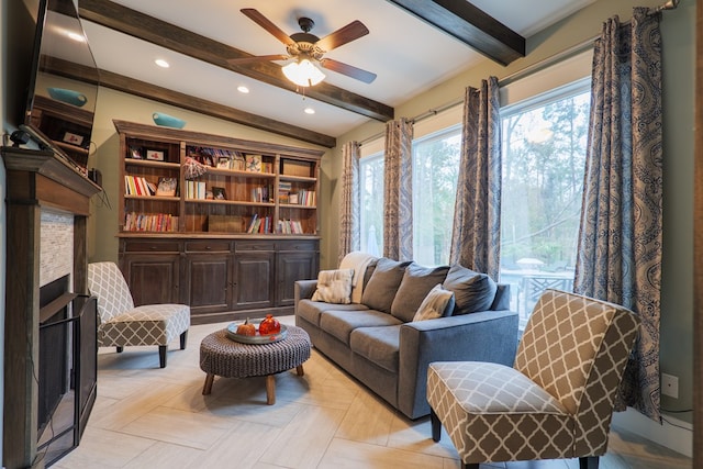 sitting room featuring vaulted ceiling with beams, ceiling fan, and light parquet flooring