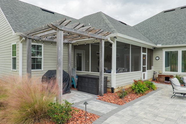 exterior space with a sunroom, a patio area, and a pergola