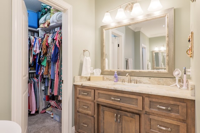 bathroom with vanity and crown molding