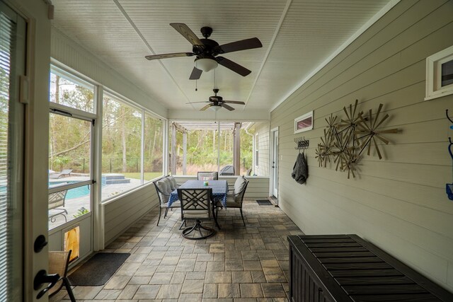 sunroom / solarium featuring ceiling fan