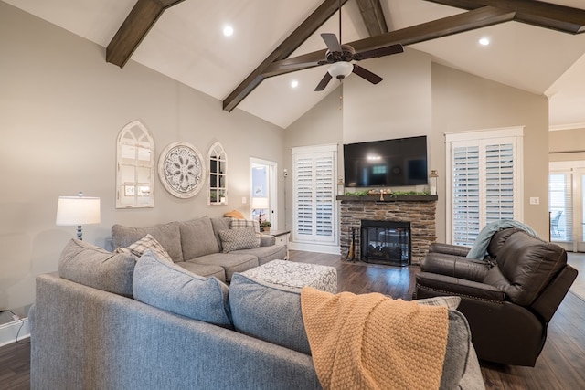 living room with ceiling fan, dark wood-type flooring, beam ceiling, high vaulted ceiling, and a fireplace