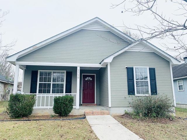 bungalow featuring a front yard and a porch