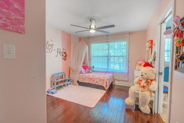 bedroom with a ceiling fan and hardwood / wood-style flooring