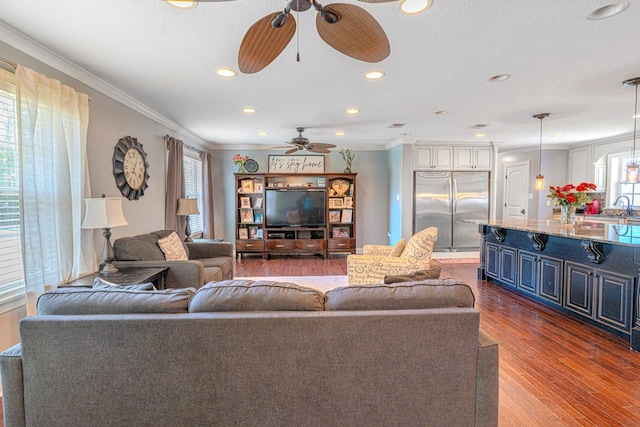 living room featuring ceiling fan, dark wood-style floors, plenty of natural light, and ornamental molding