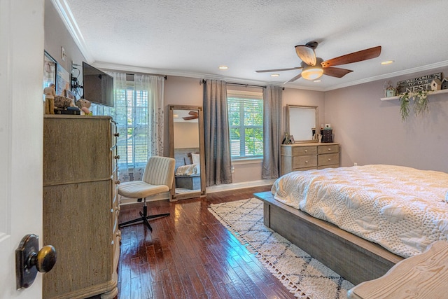 bedroom with ornamental molding, hardwood / wood-style floors, and multiple windows
