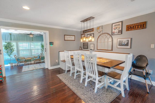 dining room with baseboards, ornamental molding, and hardwood / wood-style flooring