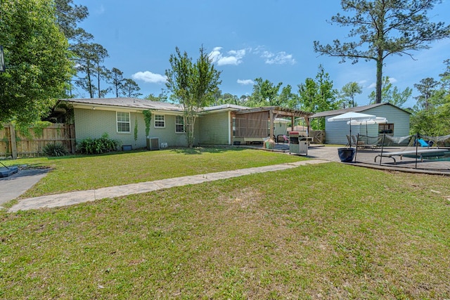 ranch-style home with fence, a pergola, a front lawn, brick siding, and a patio area