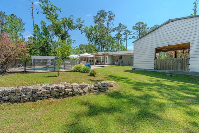 view of yard with a patio, a fenced in pool, and a fenced backyard