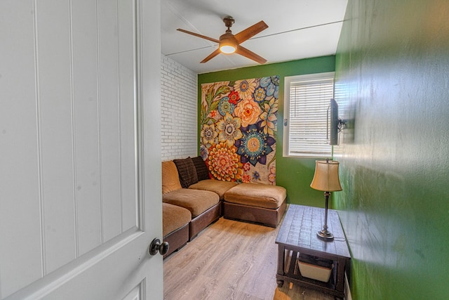 living room with ceiling fan and wood finished floors