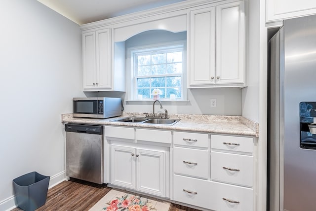 kitchen with sink, white cabinets, stainless steel appliances, and dark hardwood / wood-style floors