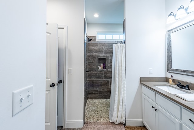 bathroom featuring a shower with curtain, vanity, and a tiled fireplace