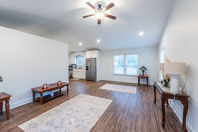 living area with vaulted ceiling, ceiling fan, sink, and dark hardwood / wood-style floors