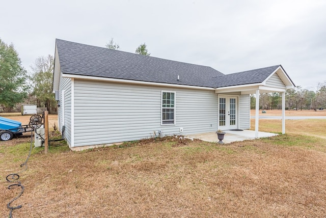 view of home's exterior with french doors, a yard, and a patio area