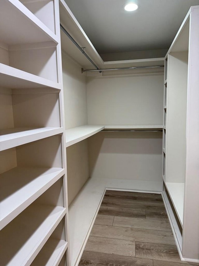 spacious closet featuring hardwood / wood-style flooring