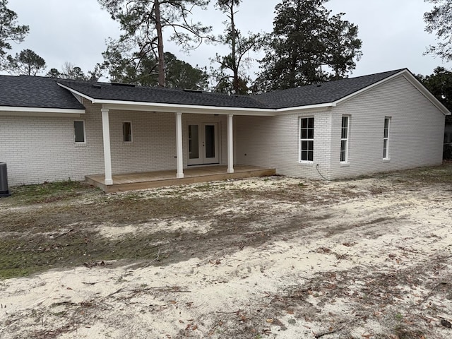 back of house with cooling unit and french doors