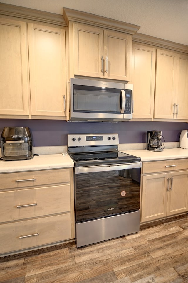 kitchen featuring light countertops, light wood-style flooring, and stainless steel appliances