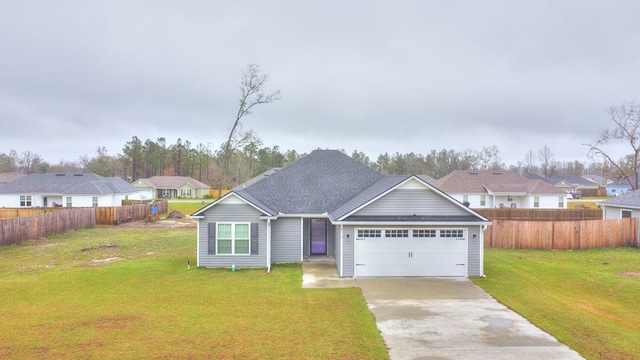 view of front facade with a front yard, an attached garage, fence, and driveway