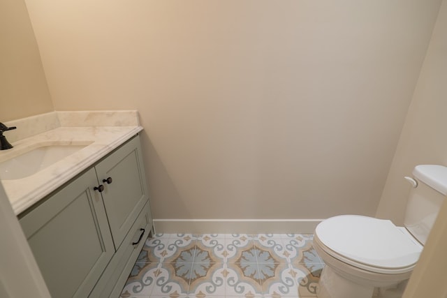 bathroom featuring vanity, tile patterned floors, and toilet