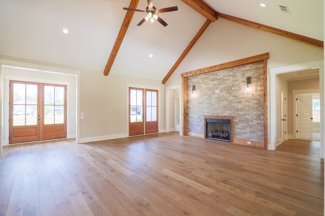 unfurnished living room featuring hardwood / wood-style floors, plenty of natural light, and french doors