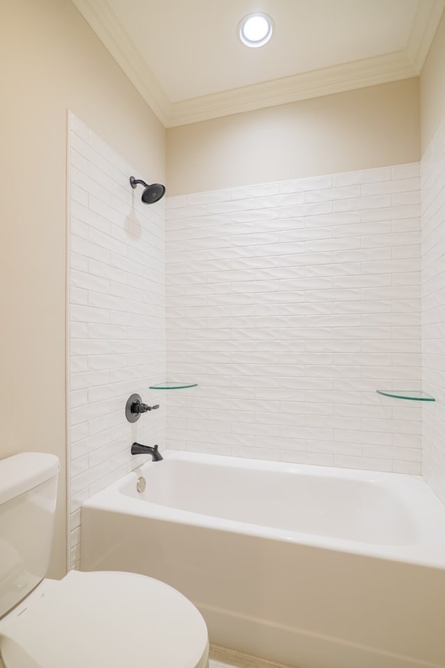 bathroom with tiled shower / bath, ornamental molding, and toilet